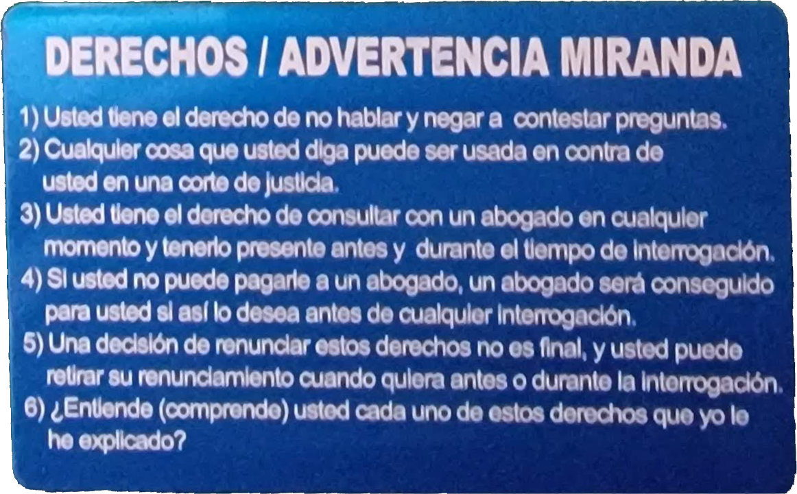 Blue aluminum Miranda warning card engraved with the Spanish text