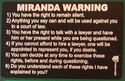 Black aluminum Miranda warning card engraved with the English text
